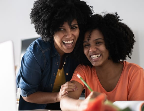 Mother and daughter smiling